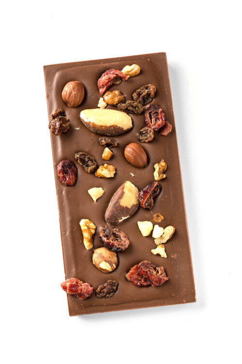 milk chocolate topped with fruit and nut